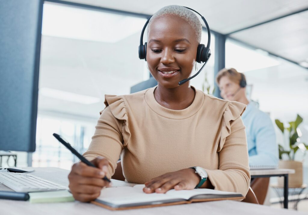 CRM, notebook and planning telemarketing consultant woman writing strategy, solution or idea with s