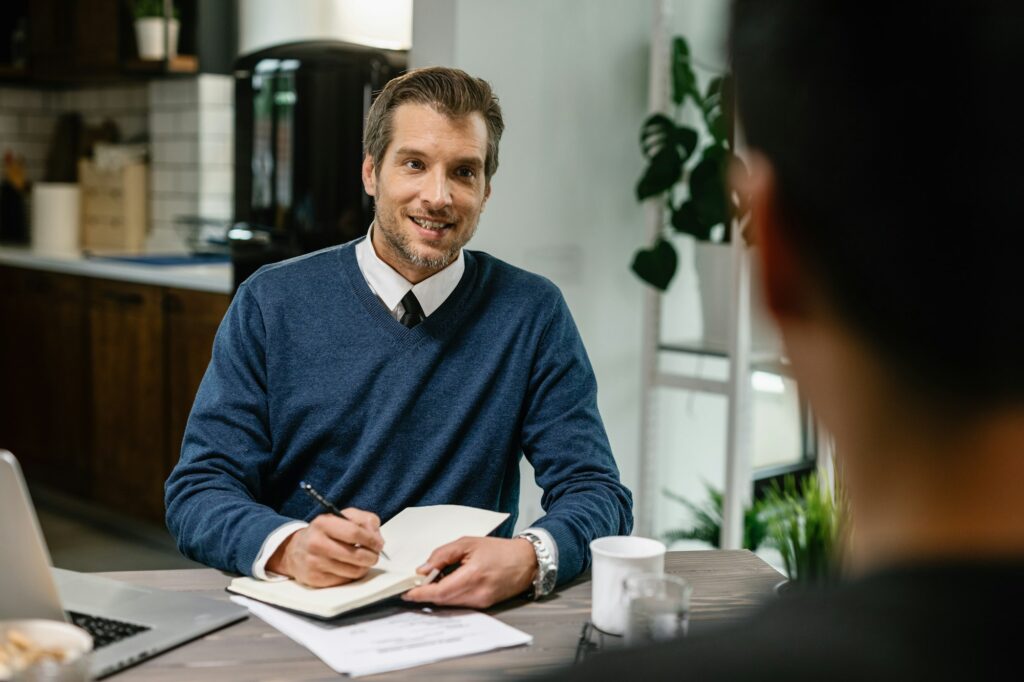 Financial consultant planning home finances with his client.