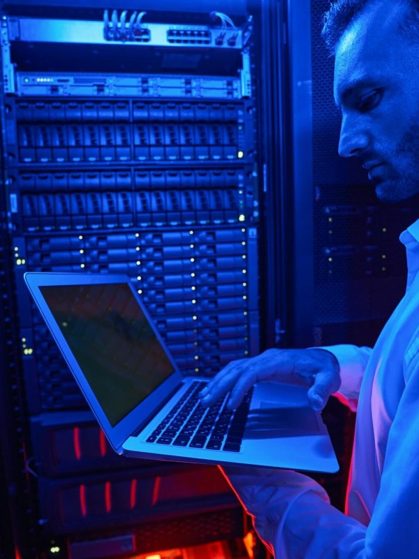 Server engineer with laptop working on data security issues