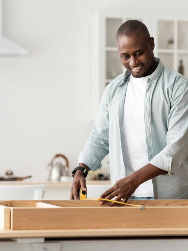 Handyman working at home, repairing, assembling and renovation or new hobby. Man measuring new table